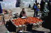 a girl selling tomatoes